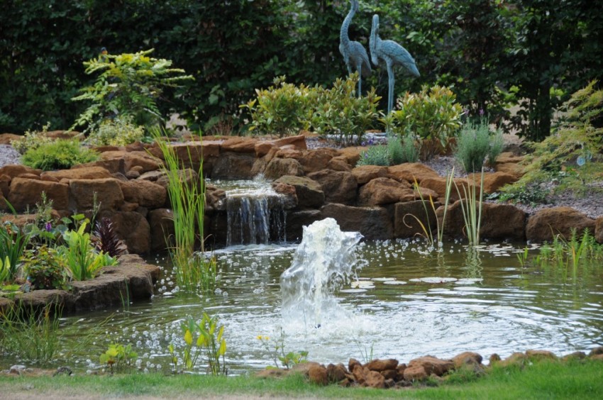 Carrstone koi pond with waterfall, fountain and landscaping