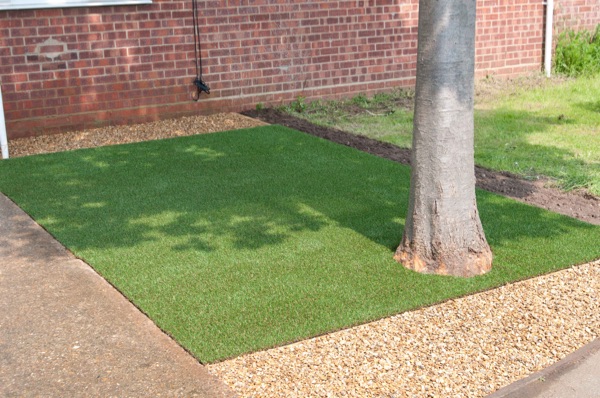 Artificial turf with a tree and surrounding shingle